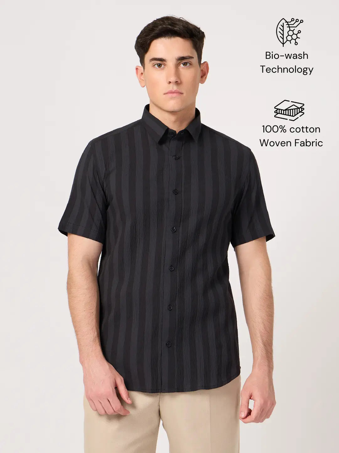 A man wearing a striped half sleeve shirt.