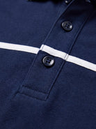 Close-up of a navy blue polo shirt with a white horizontal stripe across the chest
