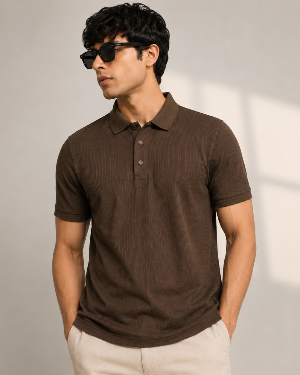 A man wearing a dark brown ribbed short-sleeve polo t shirt