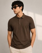 A man wearing a dark brown ribbed short-sleeve polo t shirt