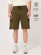 Person wearing olive green shorts on a white background