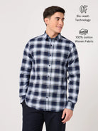 Man wearing a blue and white check shirt made with pure cotton