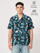 A man wearing a half-sleeve blue rayon resort shirt
