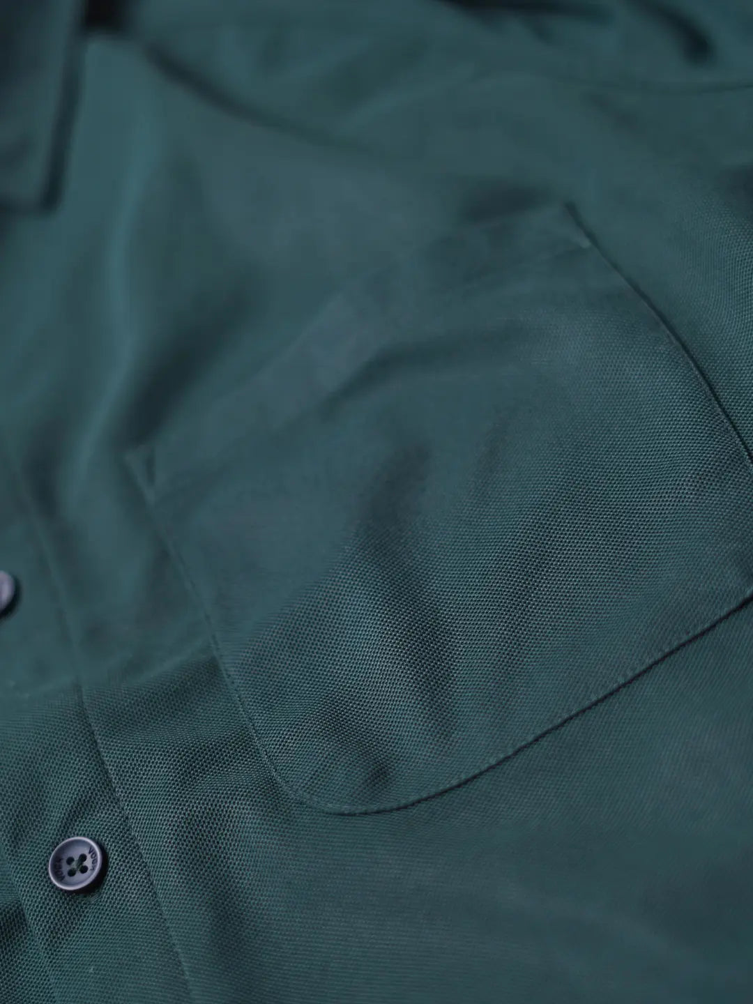Close-up of a dark forest green shirt