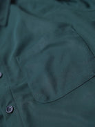 Close-up of a dark forest green shirt