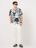 a man wearing resort shirt with a tropical print