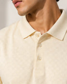 Close-up of a man wearing cream polo shirt