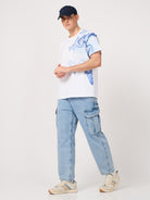 man wearing a white printed tshirt and jeans